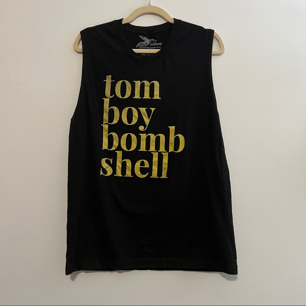 Tombomb black sleeveless tank  with gold lettering “Tom Boy Bombshell”